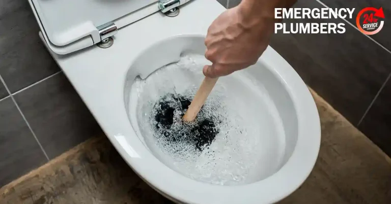 A person's hand using a plunger to unclog a toilet, with text reading "Emergency Plumbers" and "24/7 Service" in the top right corner.